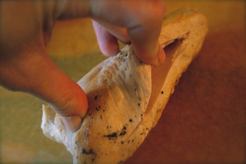 A person holding a piece of bread.