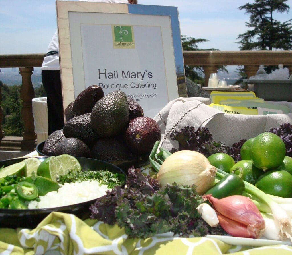 A table full of vegetables and a sign.