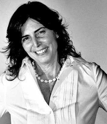 A black and white photo of a woman smiling.
