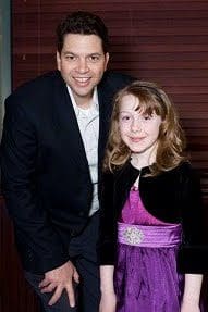A man and a young girl posing for a picture.