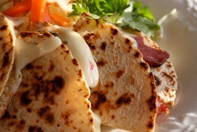 A plate of quesadillas with cheese and vegetables.