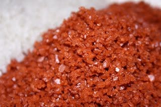A pile of red salt on top of rice.