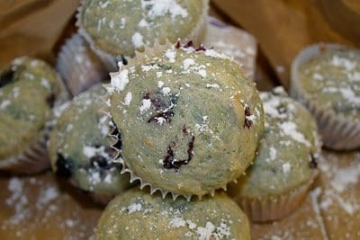 Blueberry muffins with powdered sugar.