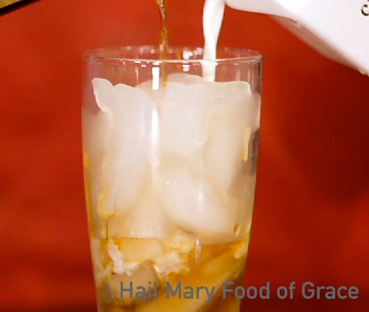 A glass of ice is being poured into a glass.