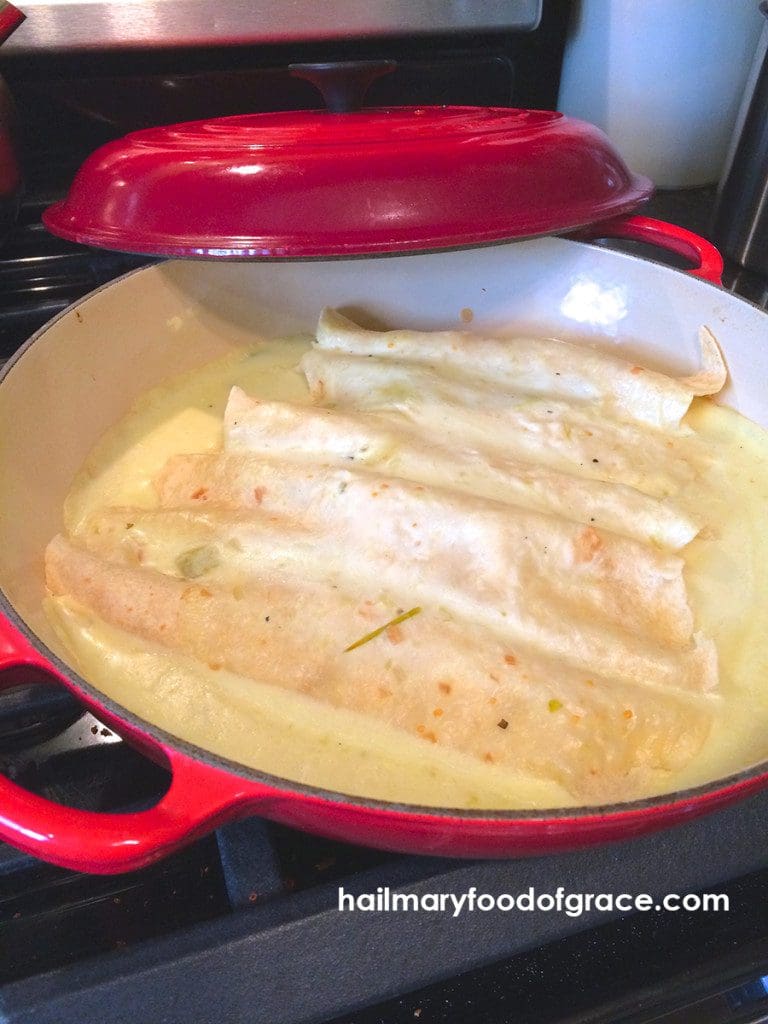 Quesadillas in a red skillet on a stovetop.