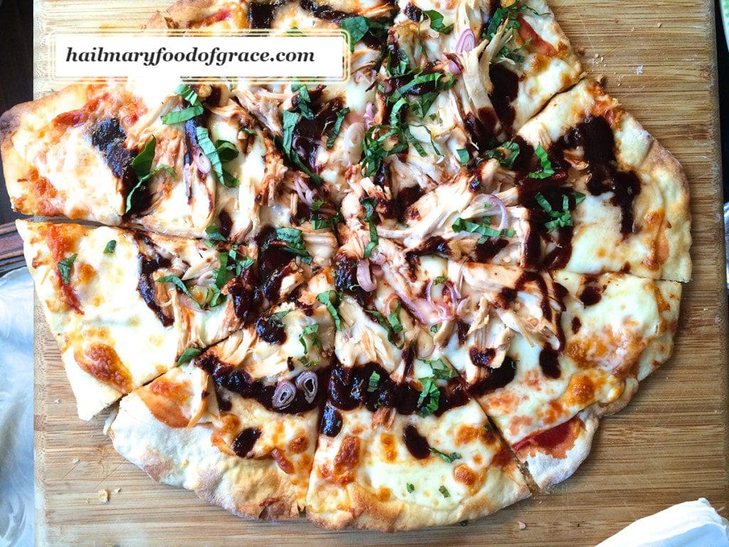 A pizza on a wooden cutting board.