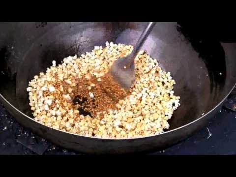 A bowl of popcorn with spices in it.