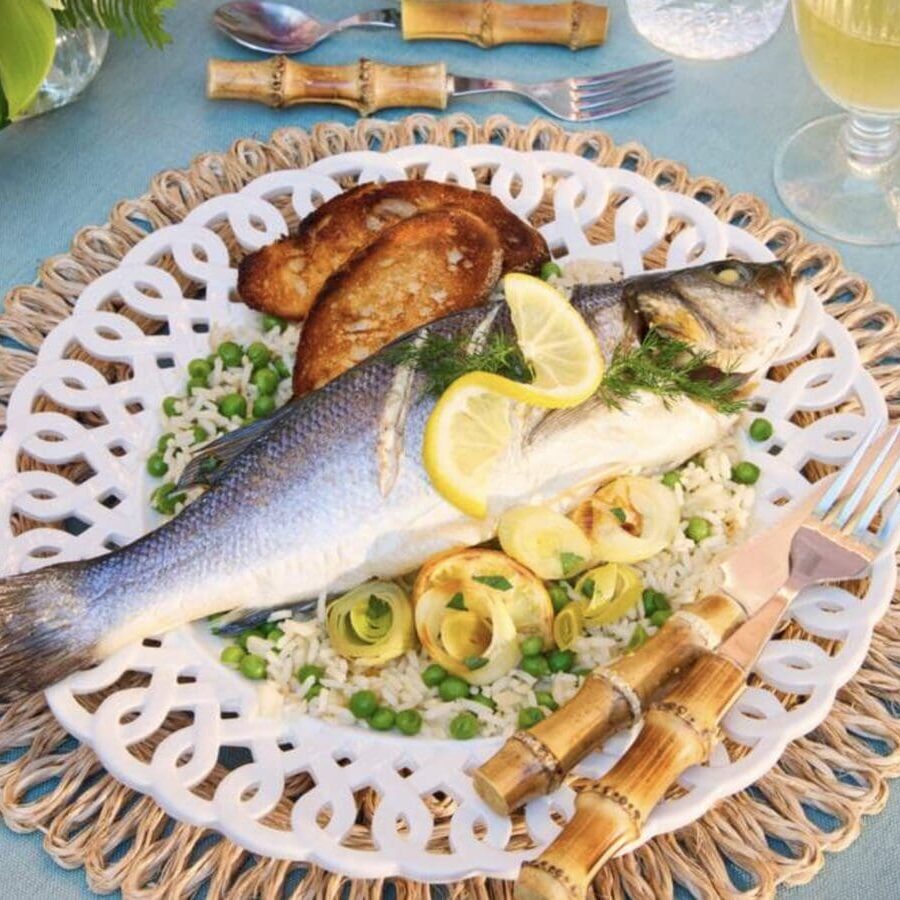 A plate with a fish and rice on it.