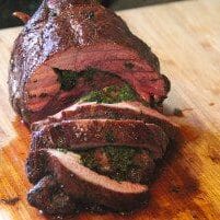 A leg of lamb resting on a cutting board.