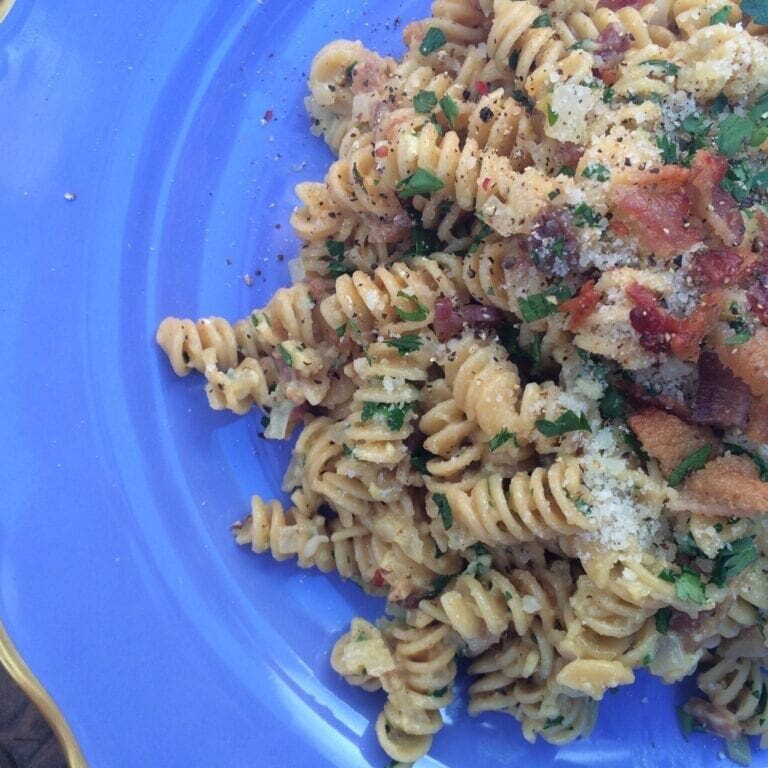 Pasta (rotini) carbonara on a blue plate