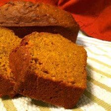 Two slices of delicious pumpkin bread on a towel.