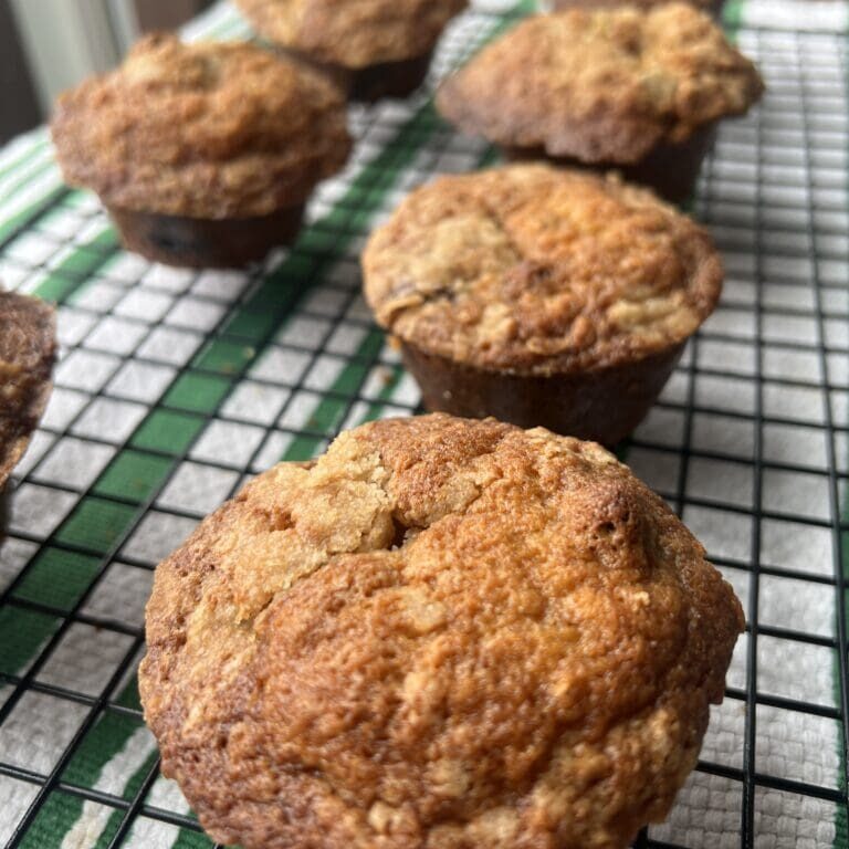 Freshly baked muffins cooling on a wire rack.