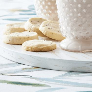 A tray with cookies and a glass of milk.