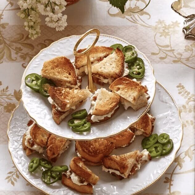 A plate of sandwiches with jalapeos on it.