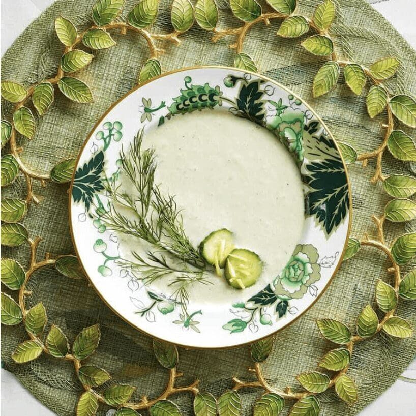 A plate with a bowl of soup on it.